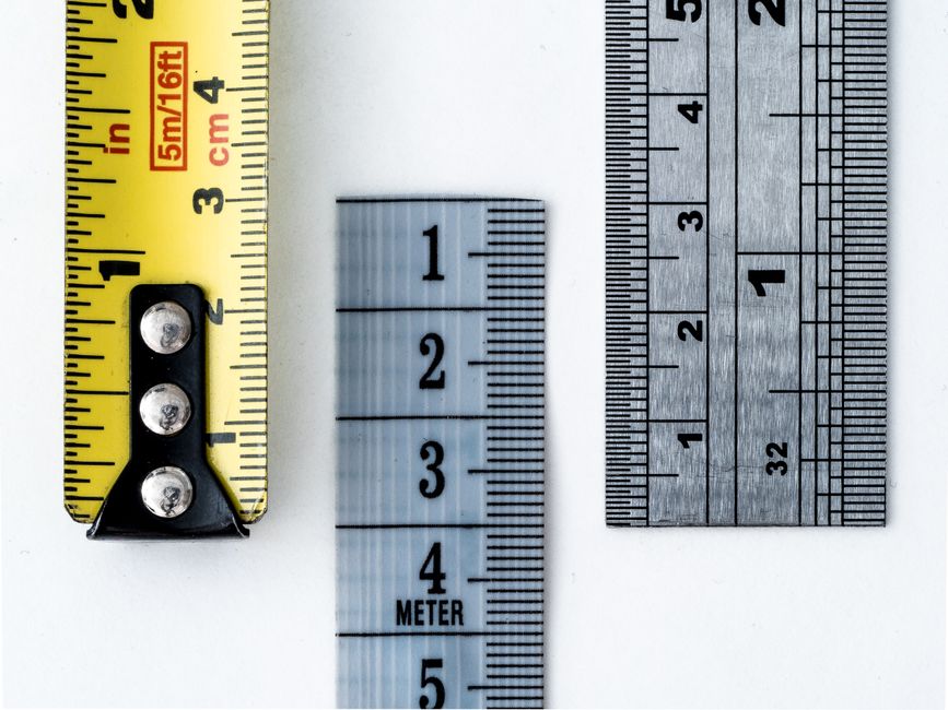 High-resolution image of a tape measure and rulers, showing precise millimeter, centimeter, and inch markings.